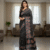 "A beautiful black and white Ajrak print sareAjrakh block print dola silk sarees made of cotton.""Ajrakh block print dola silk saree with traditional geometric pattern."